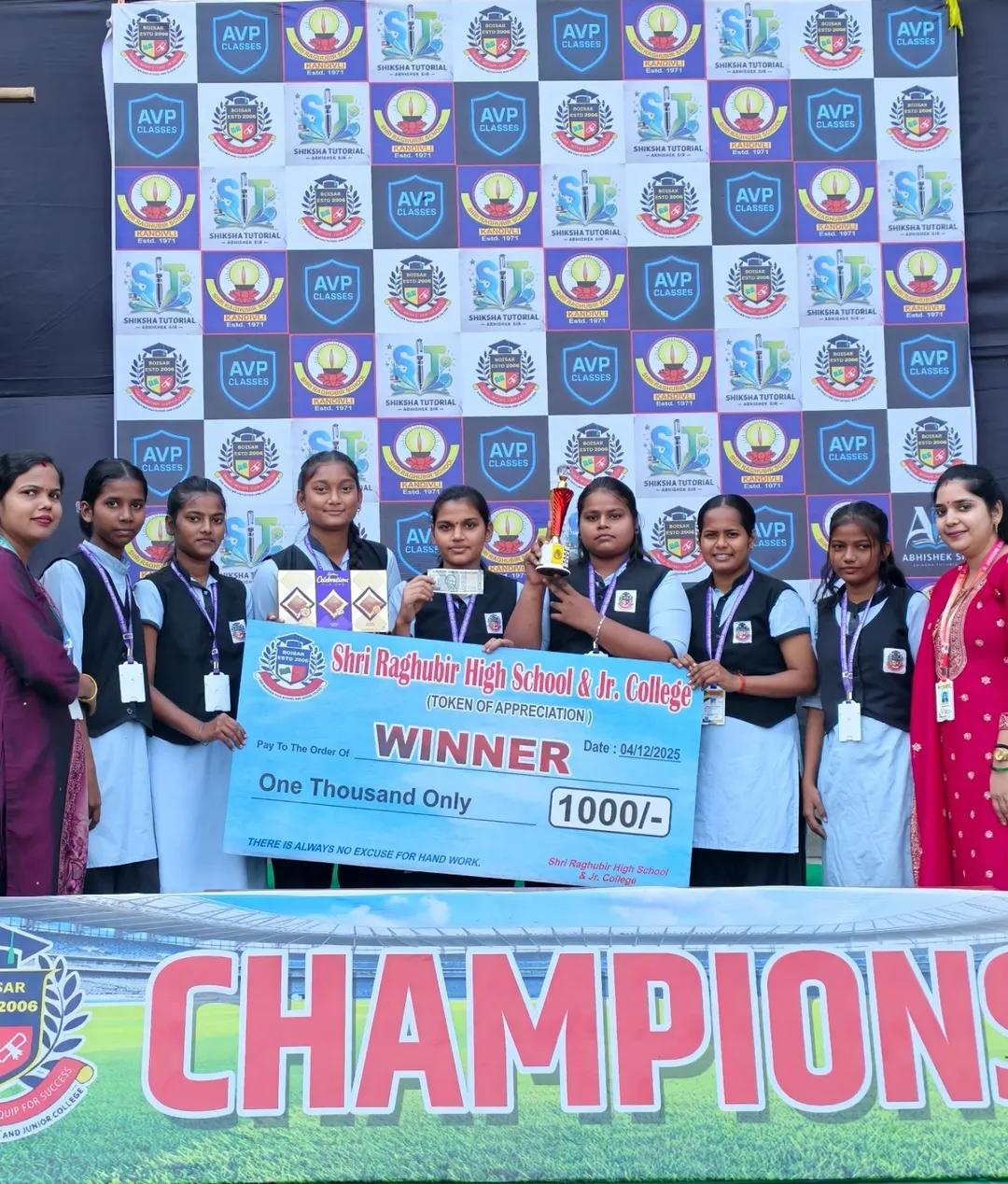 Students holding a trophy and winner cheque